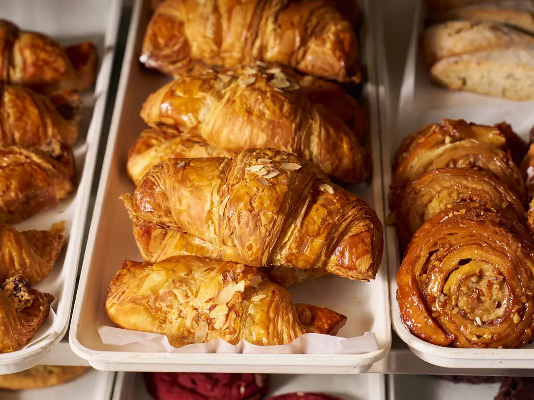 Almond croissants, chocolate croissants and pecan swirls in the Saffron bakery case