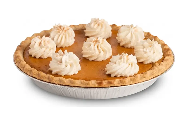 Pumpkin pie topped with whipped cream rosettes